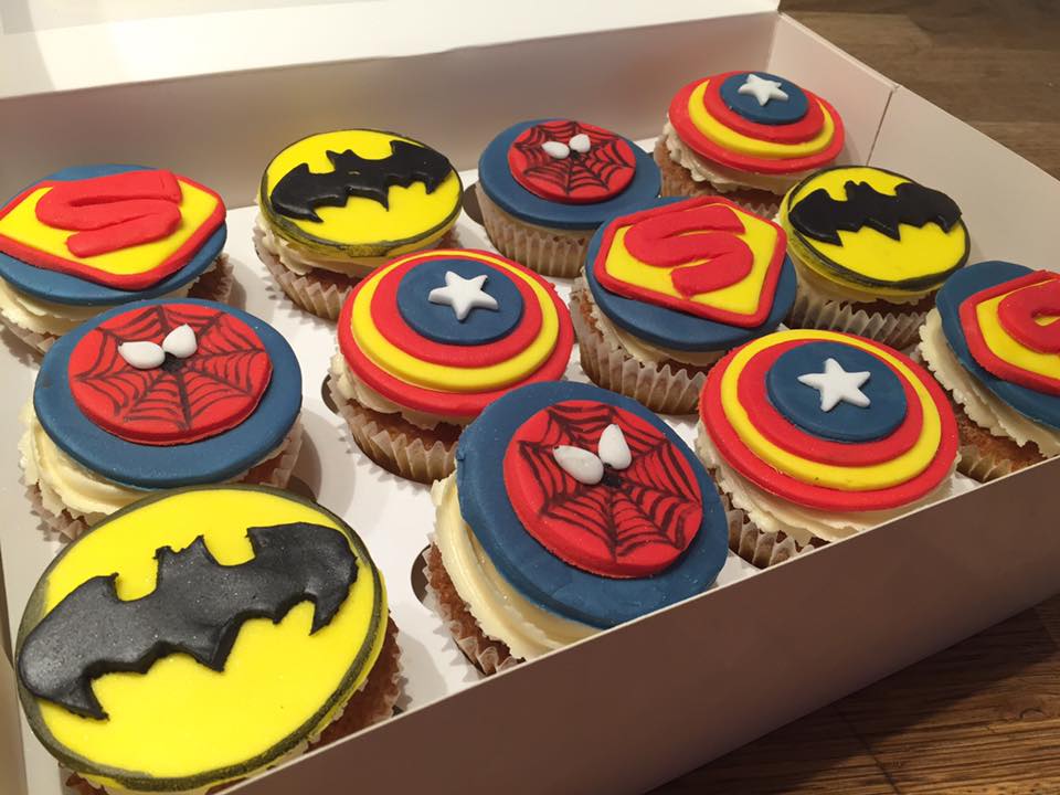 cupcakes with fondant superheroes logos on top 
