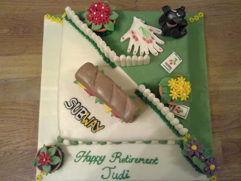 Square cake covered in fondant with one half having a fondant subway and text and the other half a garden theme with fondant flowers and dog 