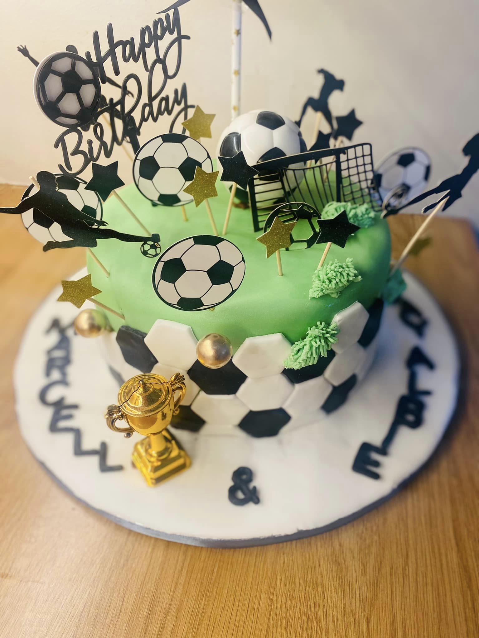 Round cake covered in fondant with lots of football cap toppers 