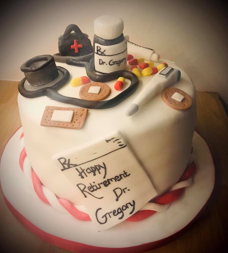 round cake covered in fondant with lots of doctors item 