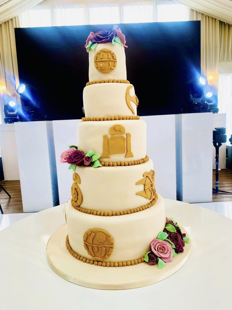 5 tier wedding cake  with fondant star wars shapes and fondant roses 