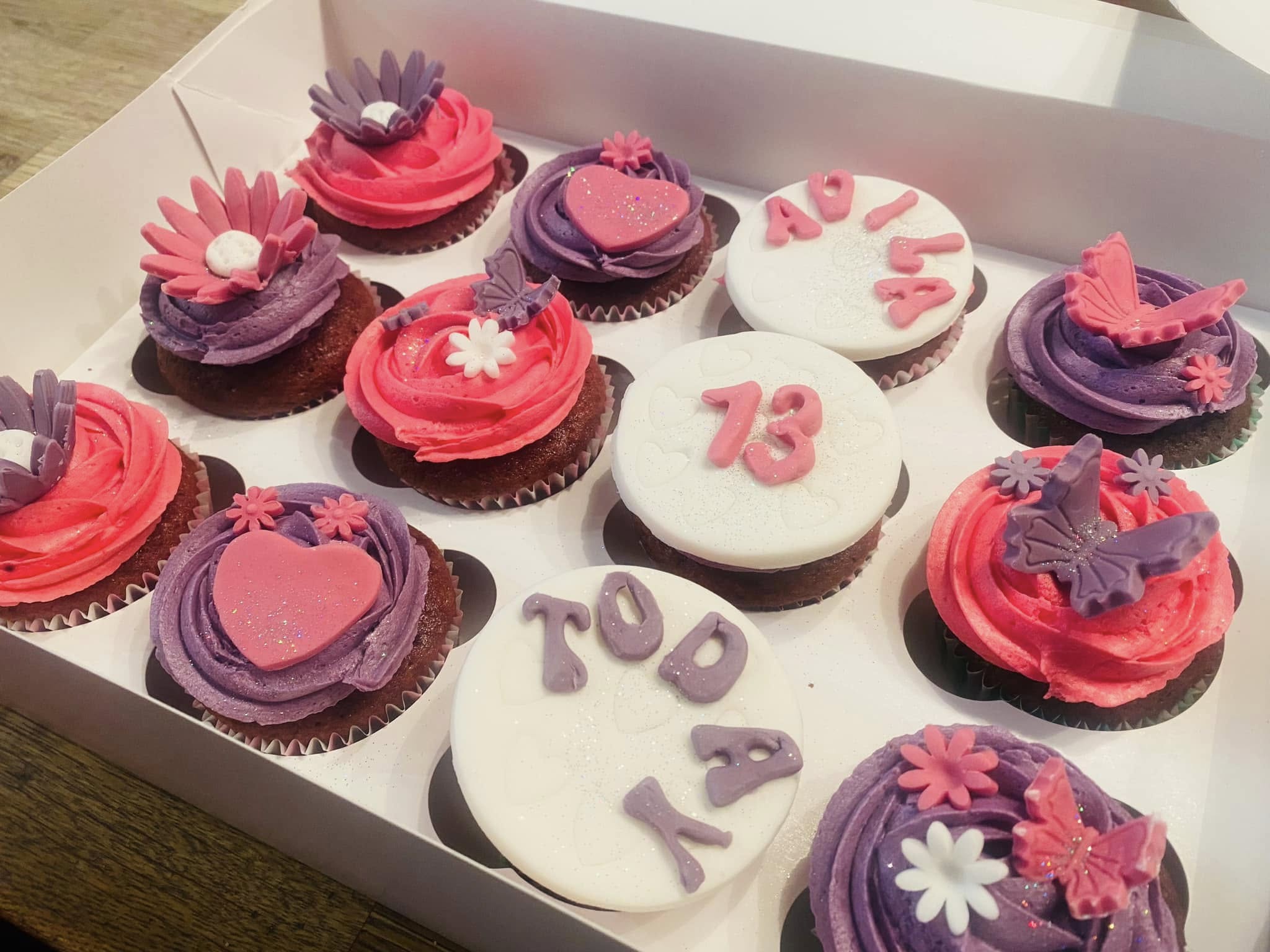 cupcakes with fondant number 12 , hearts and flowers on top 