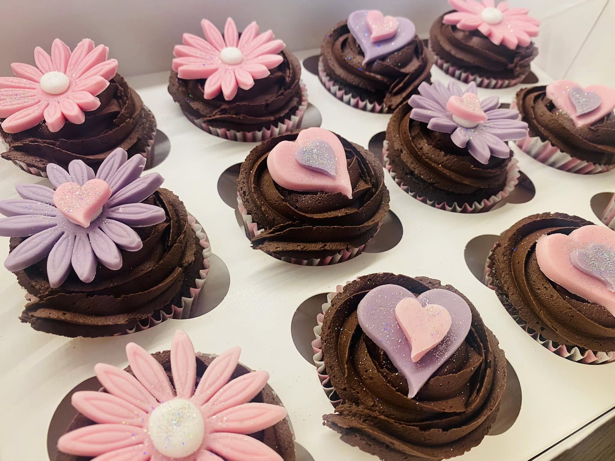 cupcakes with fondant flowers  and hearts on top