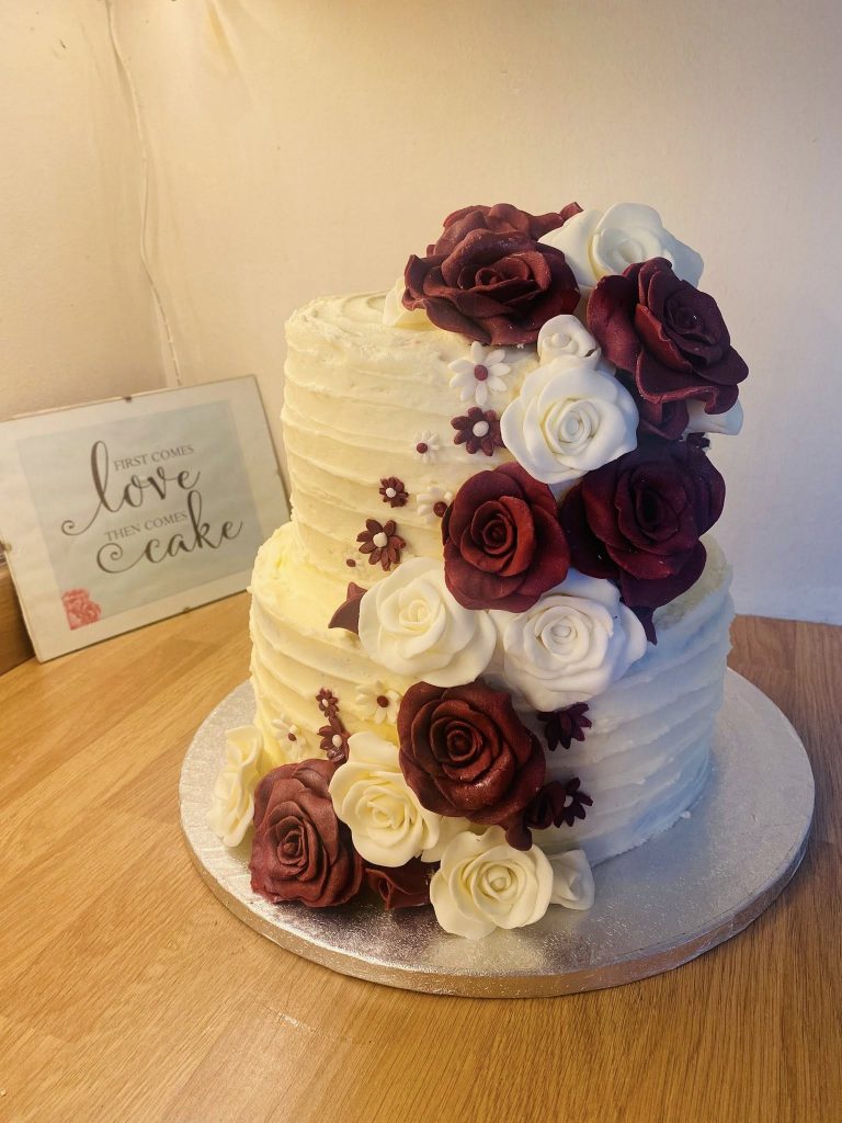 2 tier Wedding  Cakes with cream buttercream and cream and burgundy fondant roses