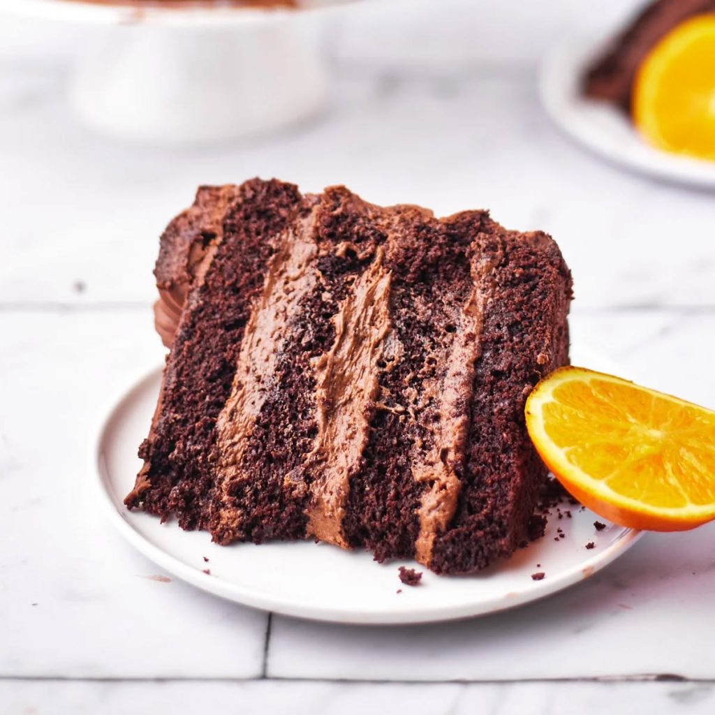 A slice of a chocolate cake with  chocolate buttercream filling about creative cakes by kaz