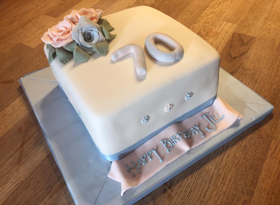 Square cake covered in fondant with a fondant number 70 and some fondant roses on top by creative cakes by kaz 