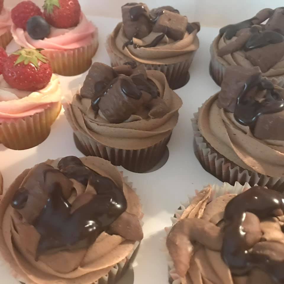 cupcakes with strawberries and chocolates on top 