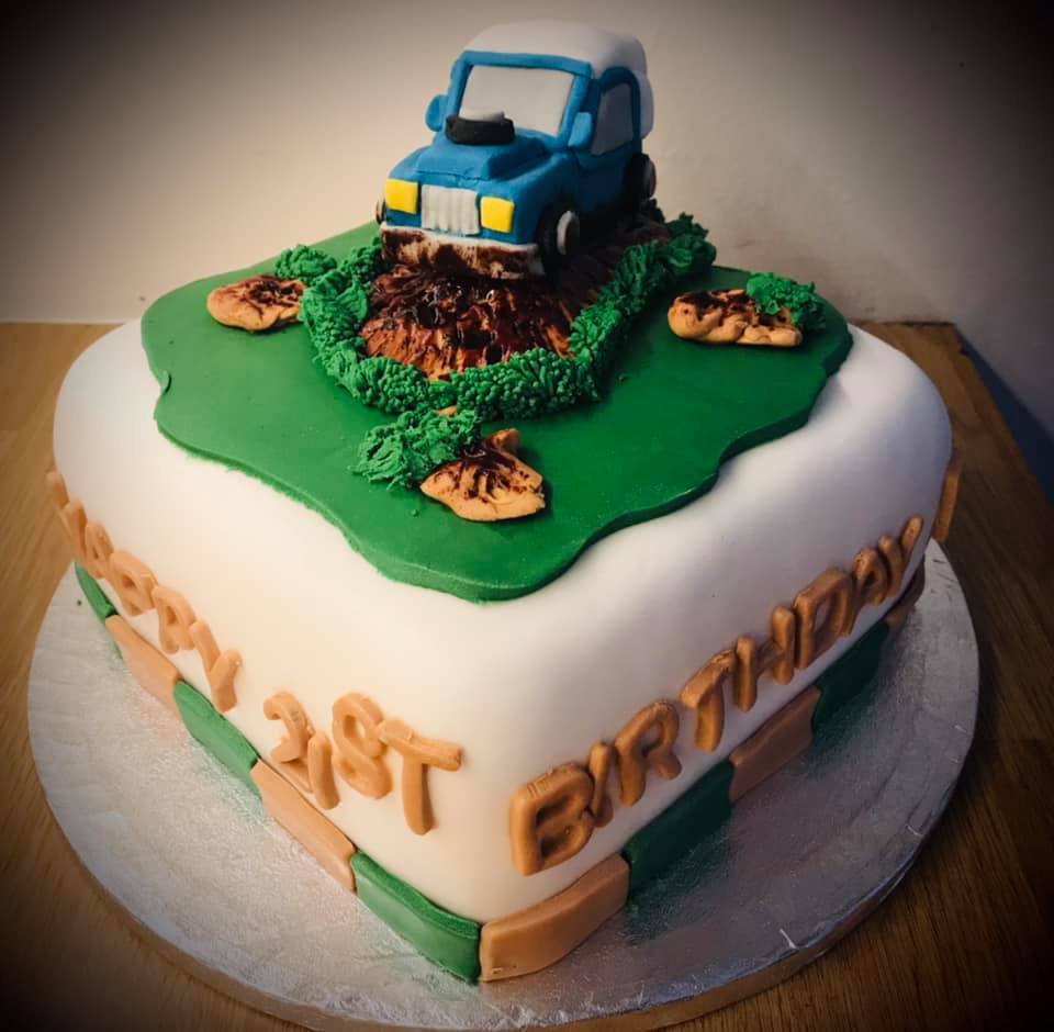 Square cake covered in fondant with fondant grass and a fondant LandRover on top by creative cakes by kaz 