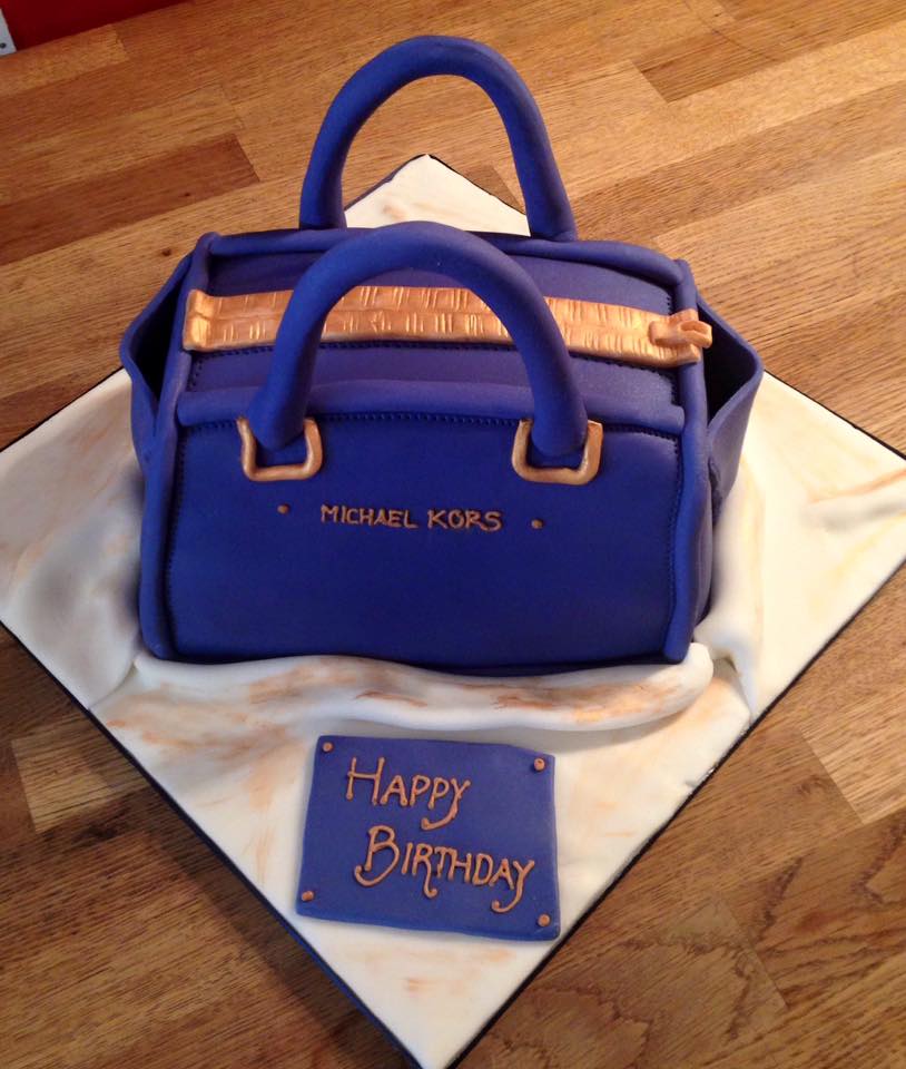 Contact page - Cake shaped into an MK hand bag covered in blue fondant