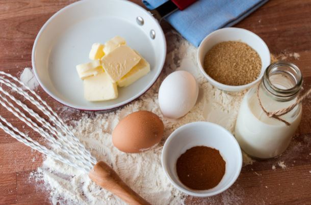 cake ingredients, eggs, flour, butter sugar with a whisk 